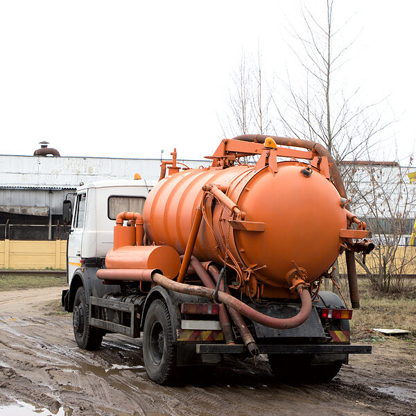 Orange Industrial Vacuum Trucks, Cesspool Machine. Back View Orange Industrial Vacuum Trucks, Cesspool Machine
